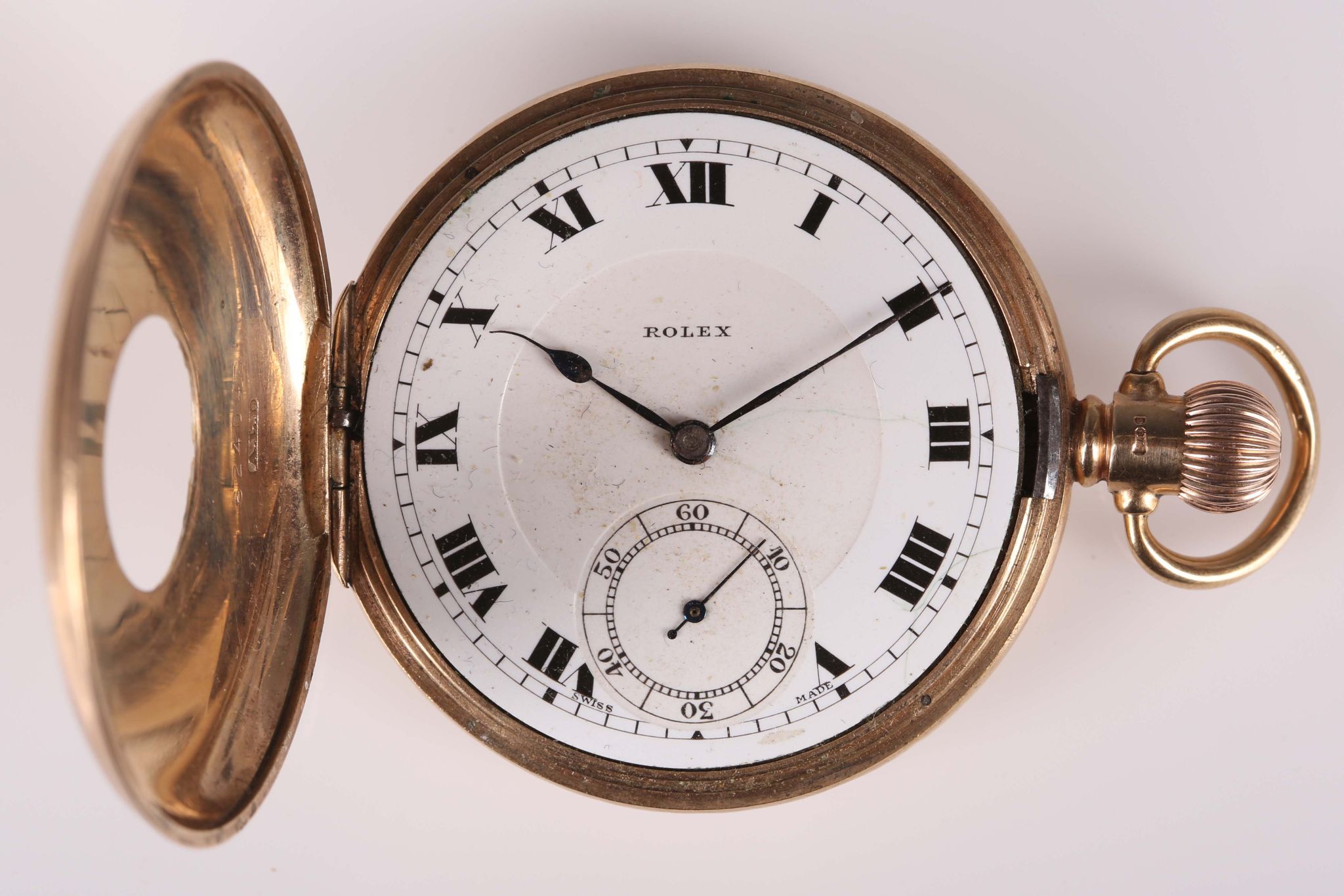 A 9ct gold half hunter pocket watch with Rolex movement, the case by Dennison.