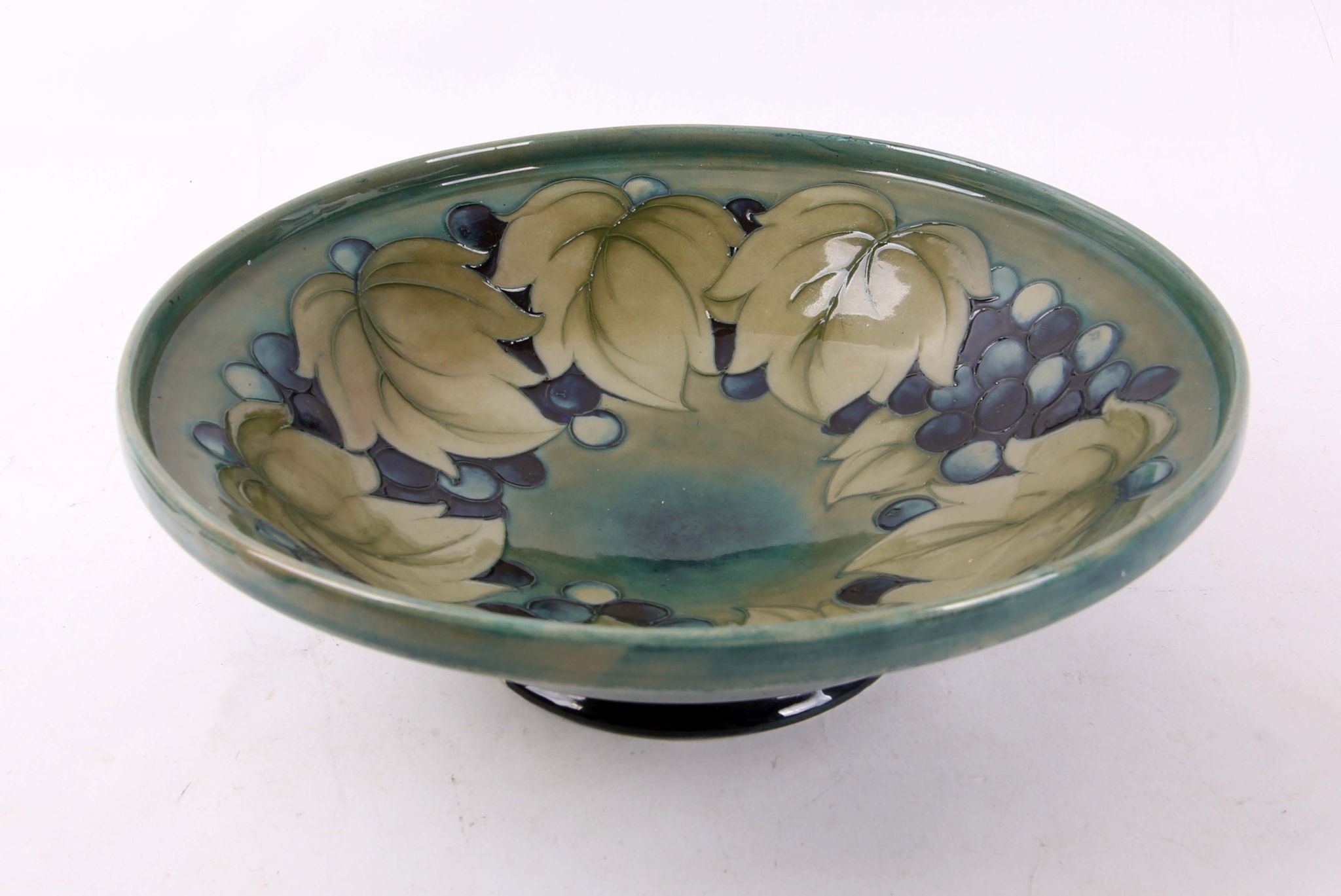 A large Moorcroft bowl, early 20th Century, with berry and leaf tubeline decoration, in blue and