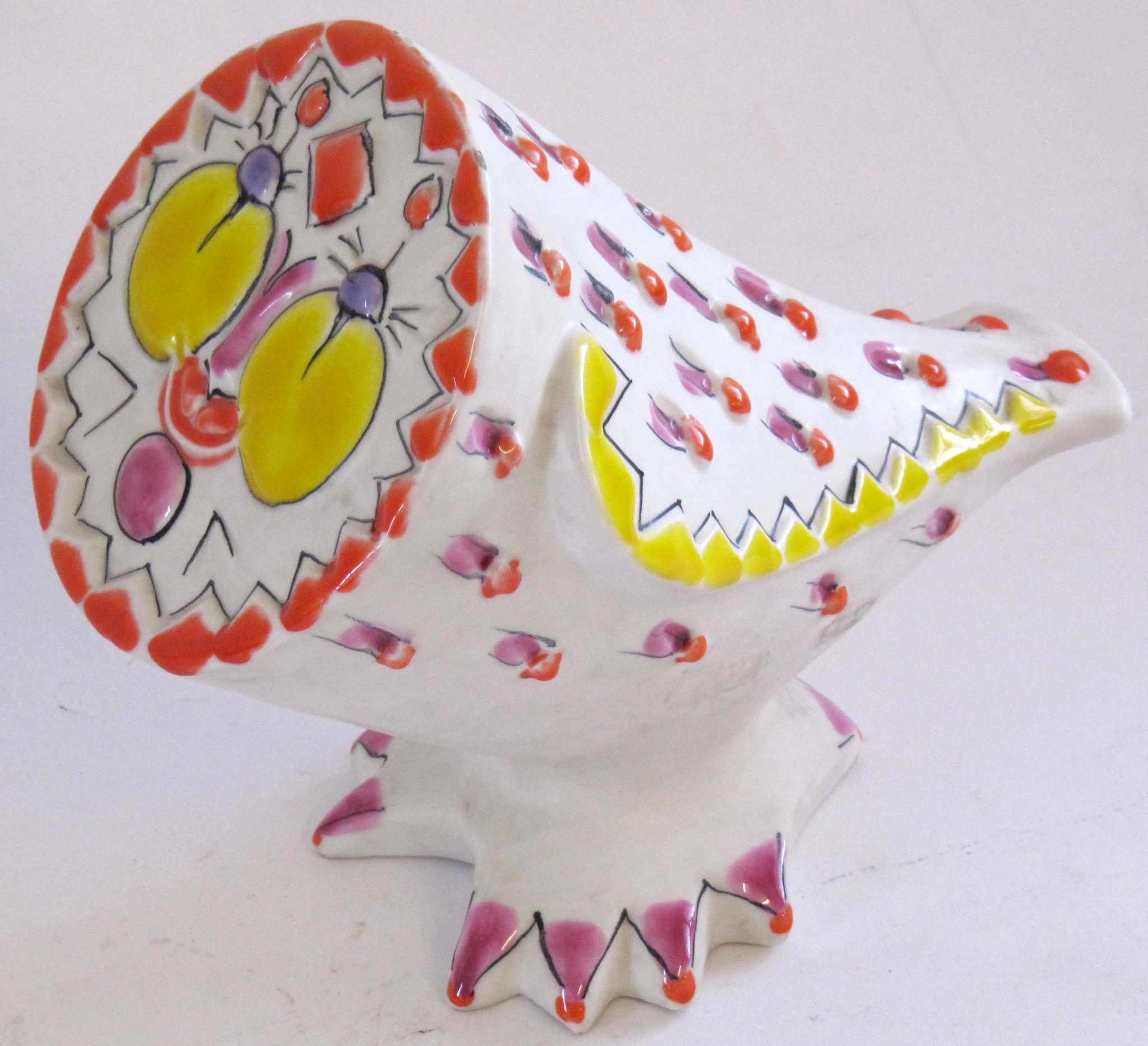 A 1960s Raymor ceramic owl, stylized owl form heightened with orange, yellow and purple glaze,