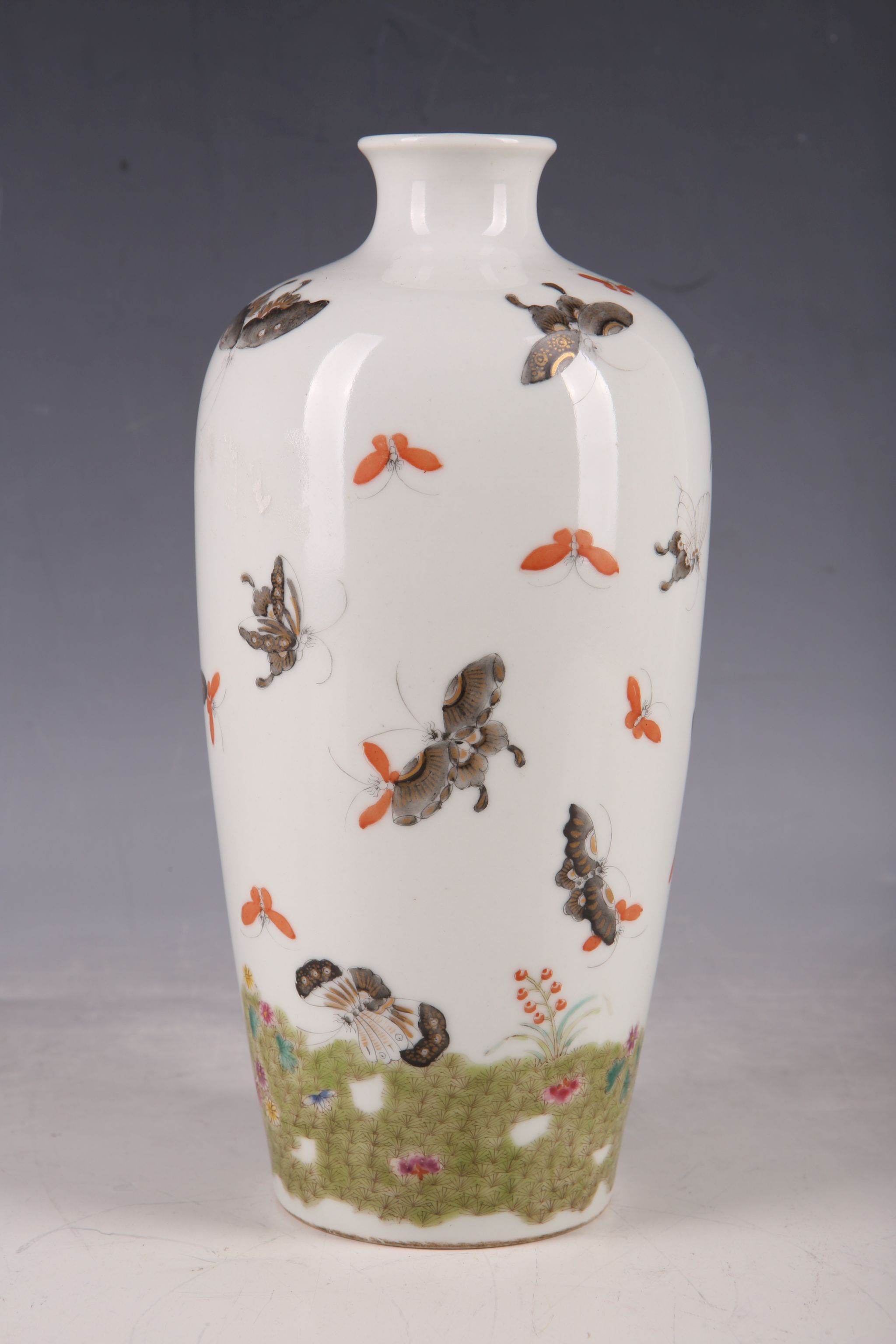 A Chinese baluster vase, all over decoration of butterflies, red character stamp to base, 21cm H.