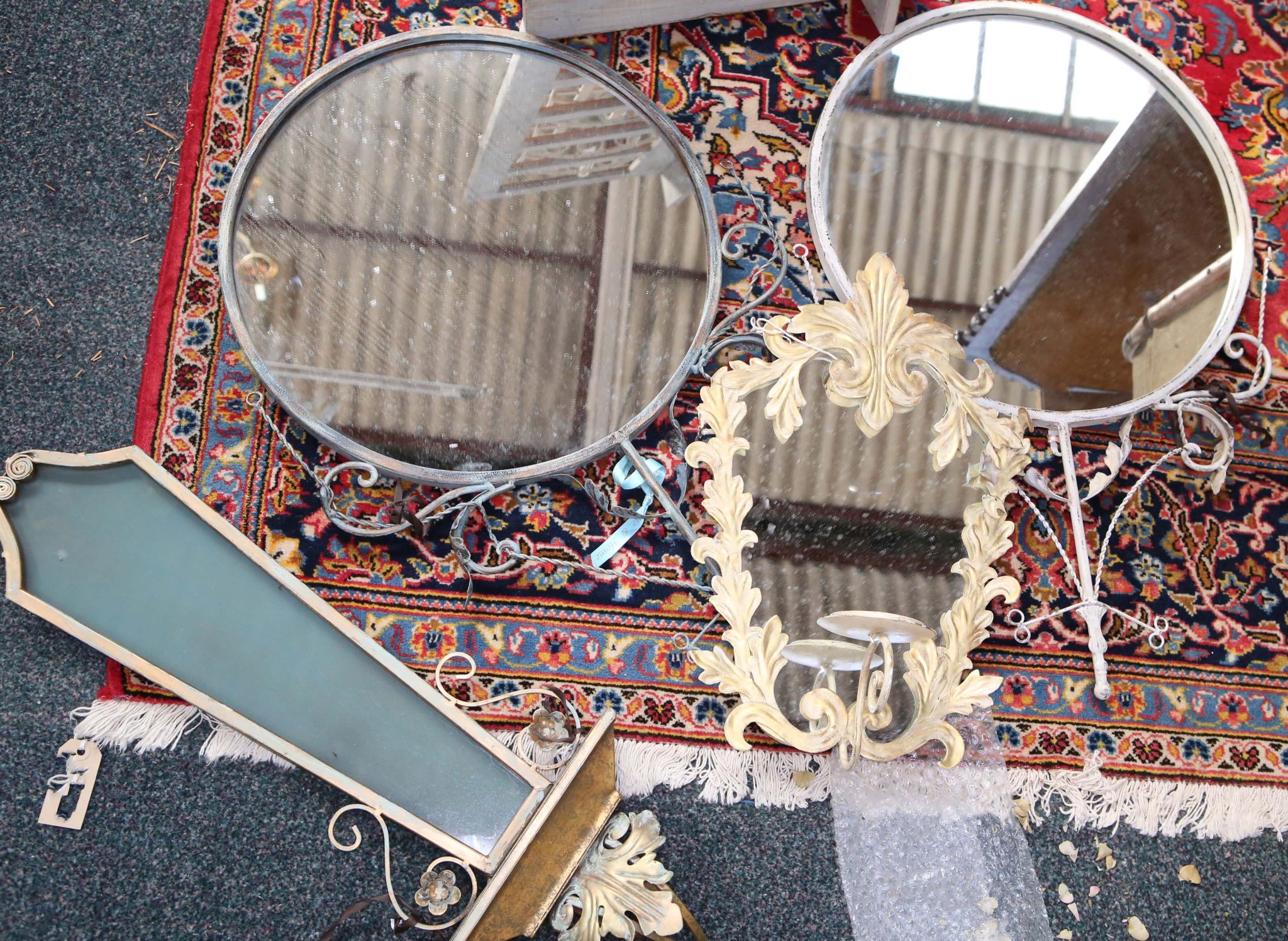 An Edwardian table top three-fold dressing mirror, sold together with two circular fancy mirrors,