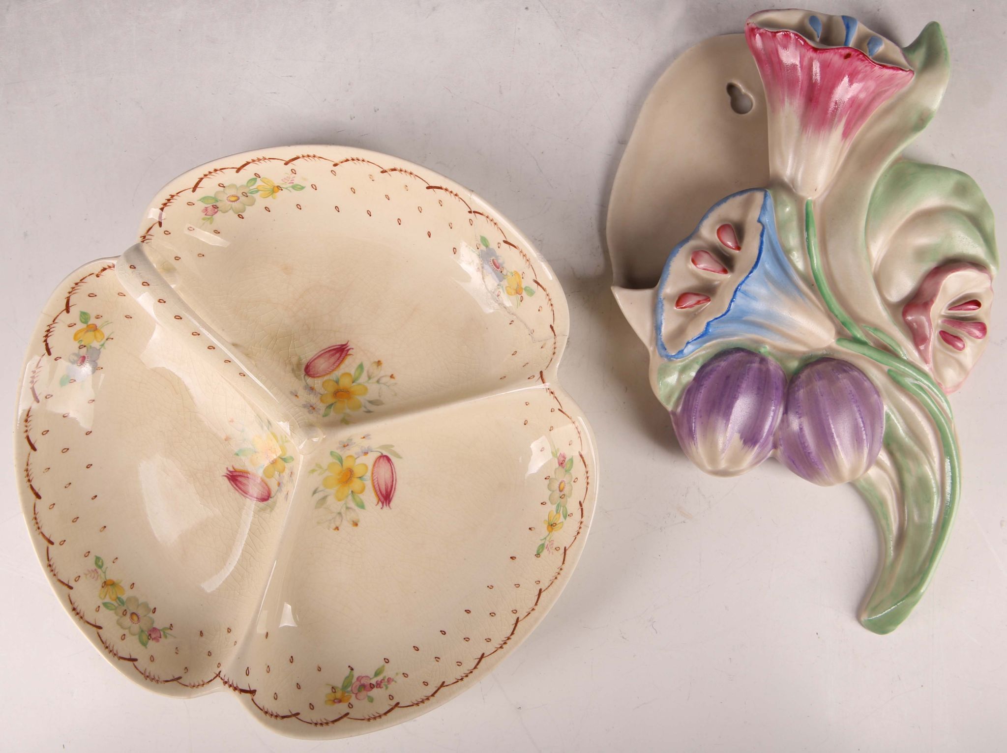 A Clarice Cliff of Wilkinson pottery wall pocket, modelled with flowerheads, together with 1930s