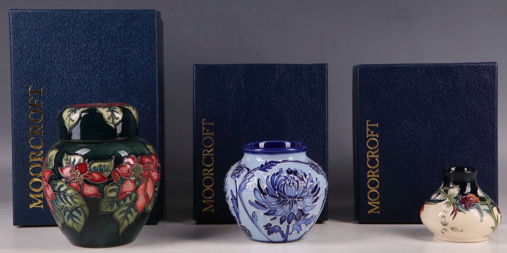 A small modern Moorcroft pottery ginger jar and cover, tube-lined with Christmas flowers in `