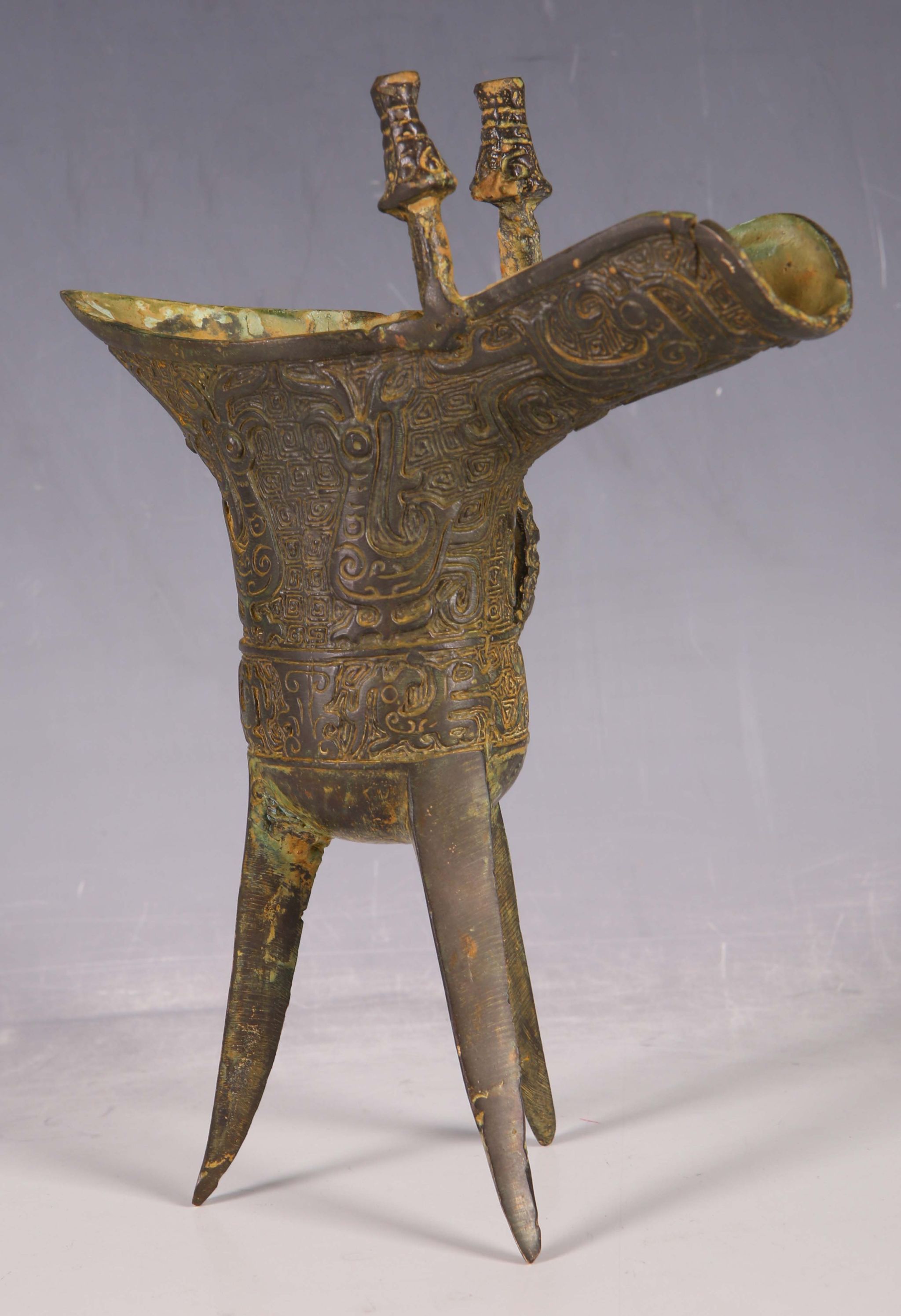 A Chinese bronze, jue wine vessel, twin lugs, mythical beast handle, all over abstract decoration, - Image 2 of 3