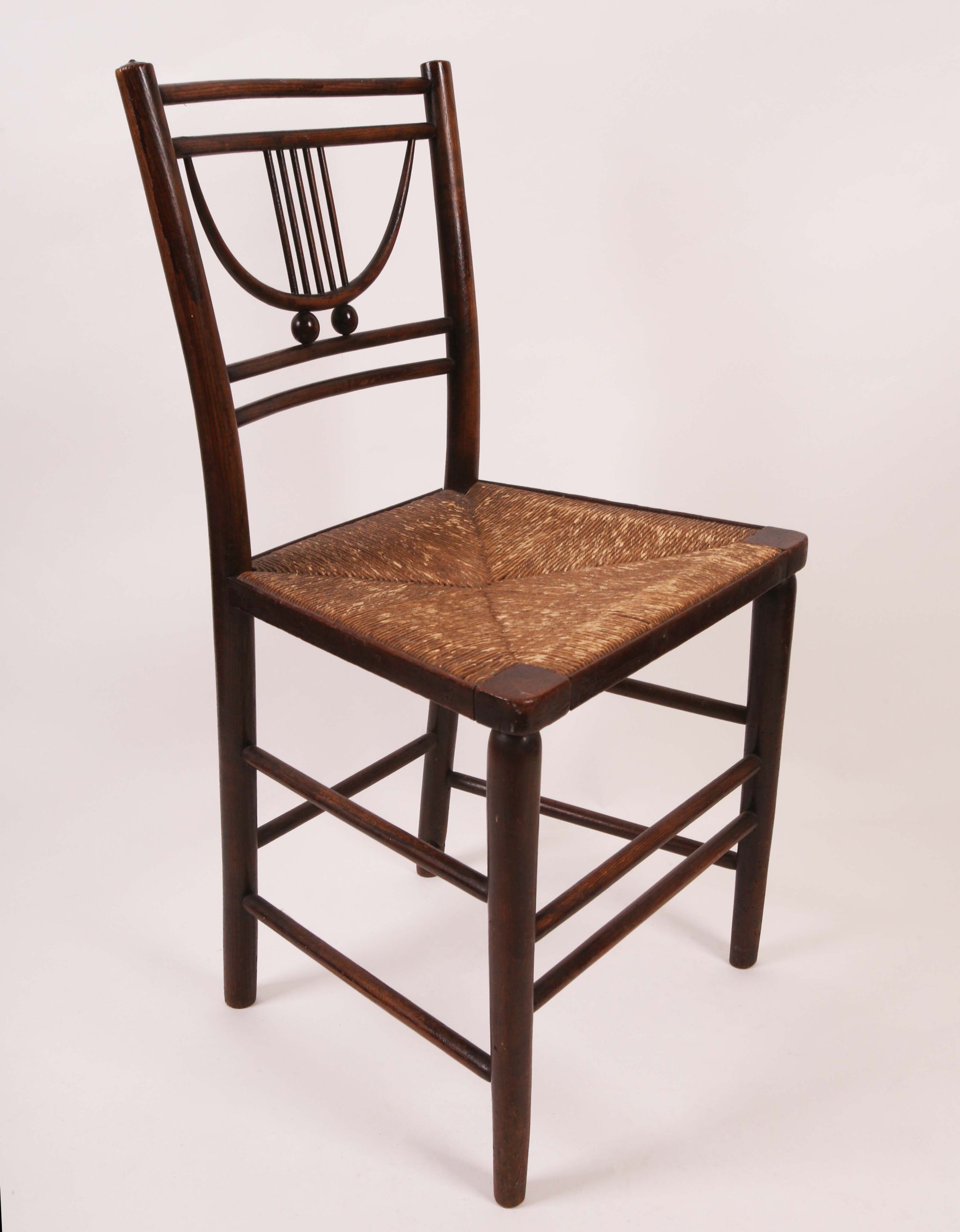 Attributed to William Morris, a late 19th century `Sussex` chair, with rush seat.