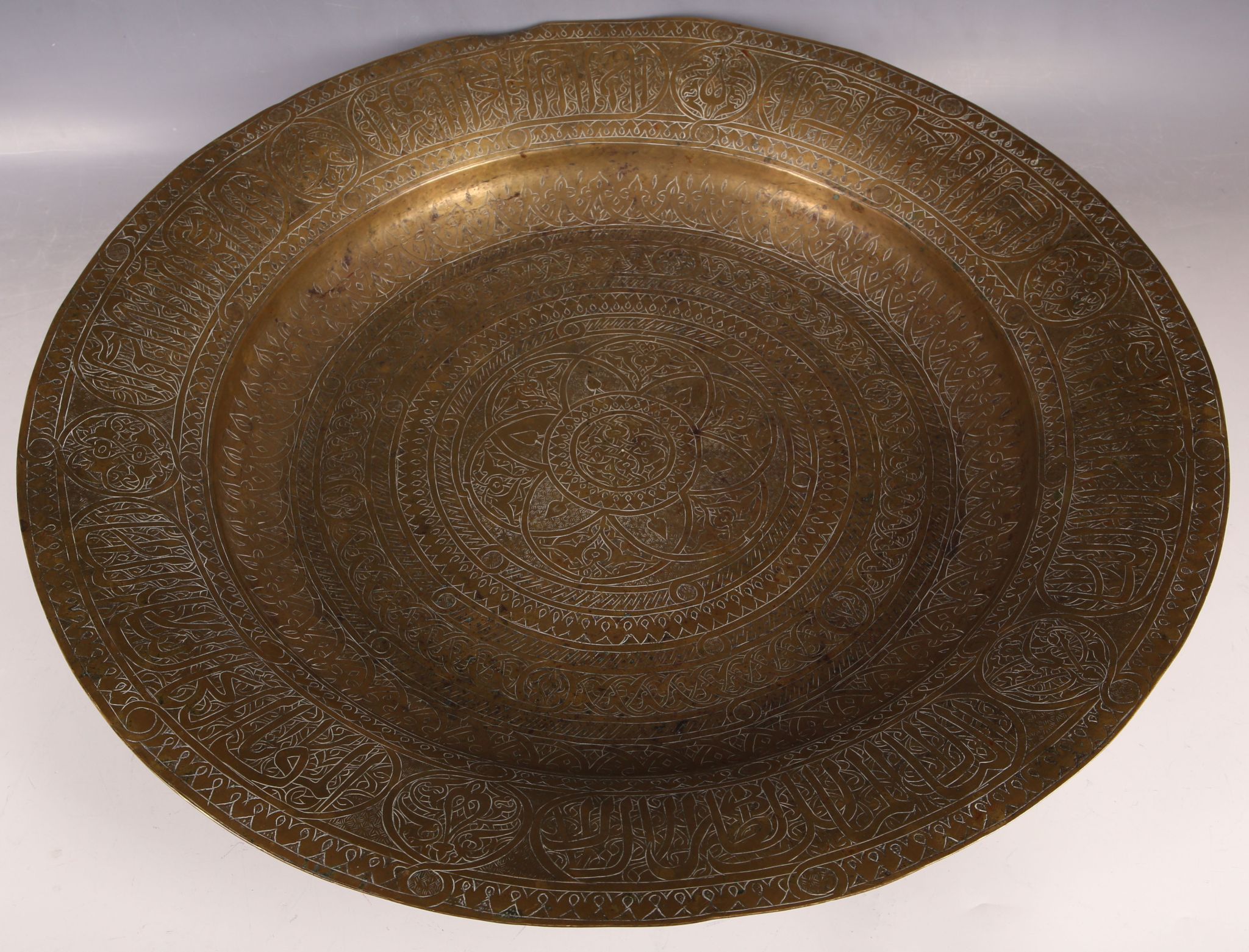A Persian 19th Century brass dish, traditional engraving, 53.6cm dia.