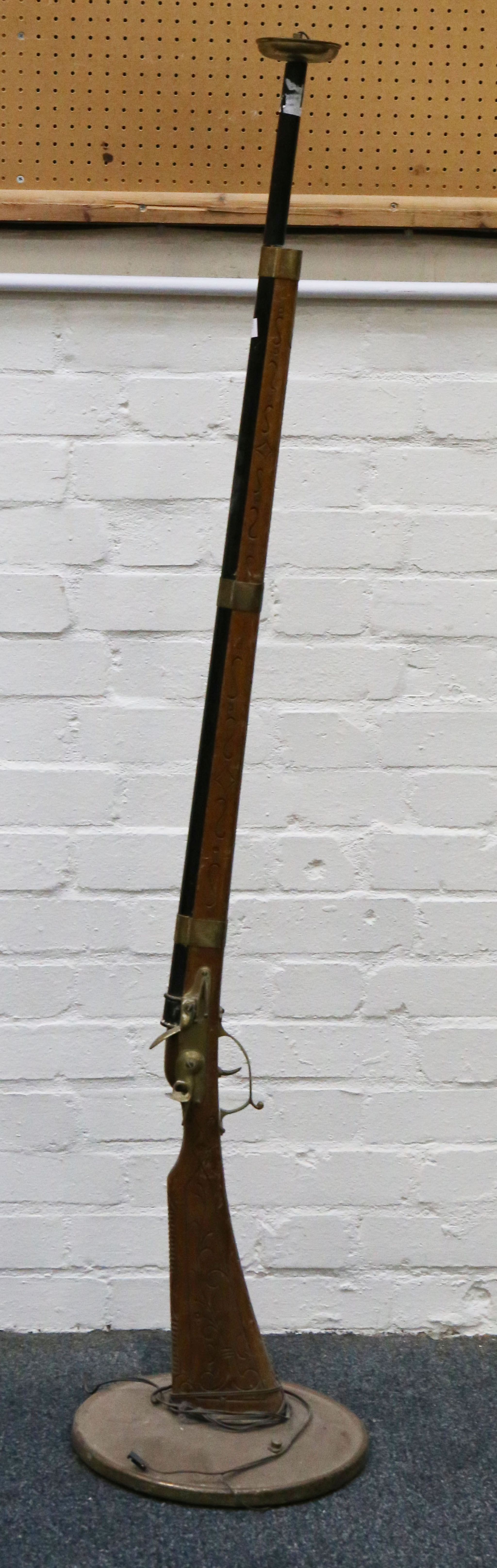A vintage standard lamp, in rifle form.