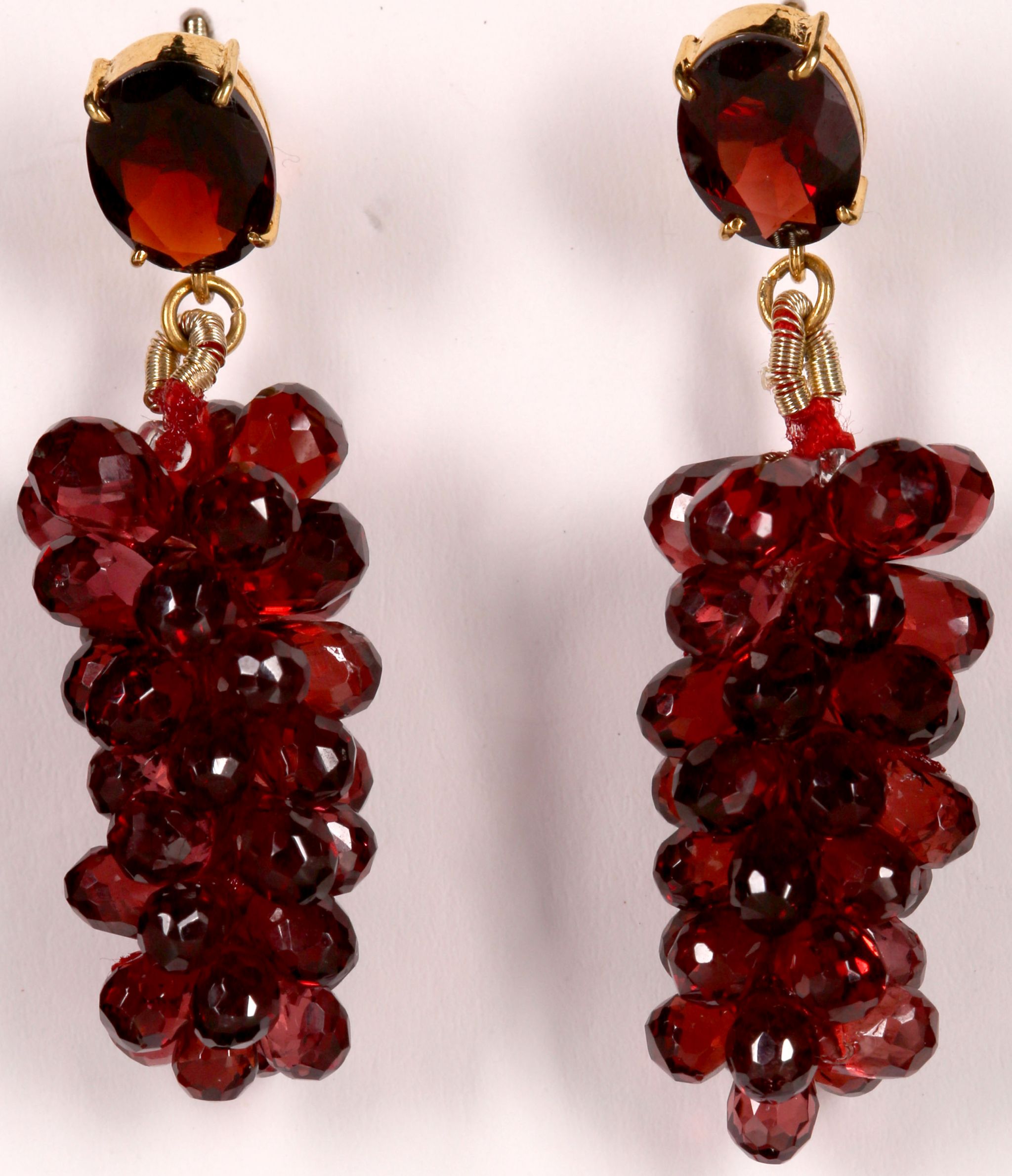 A pair of 14k gold and garnet cluster drop earrings.