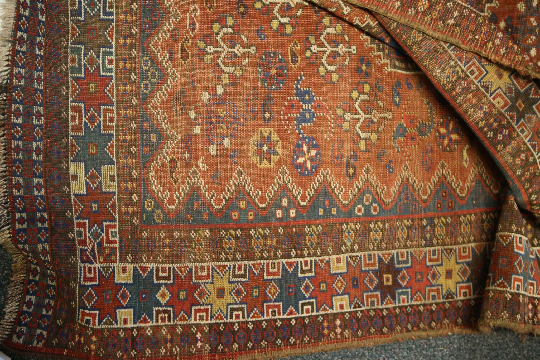 An antique Persian Qashqai rug, with co-joined diamond lozenges in shades of midnight blue and