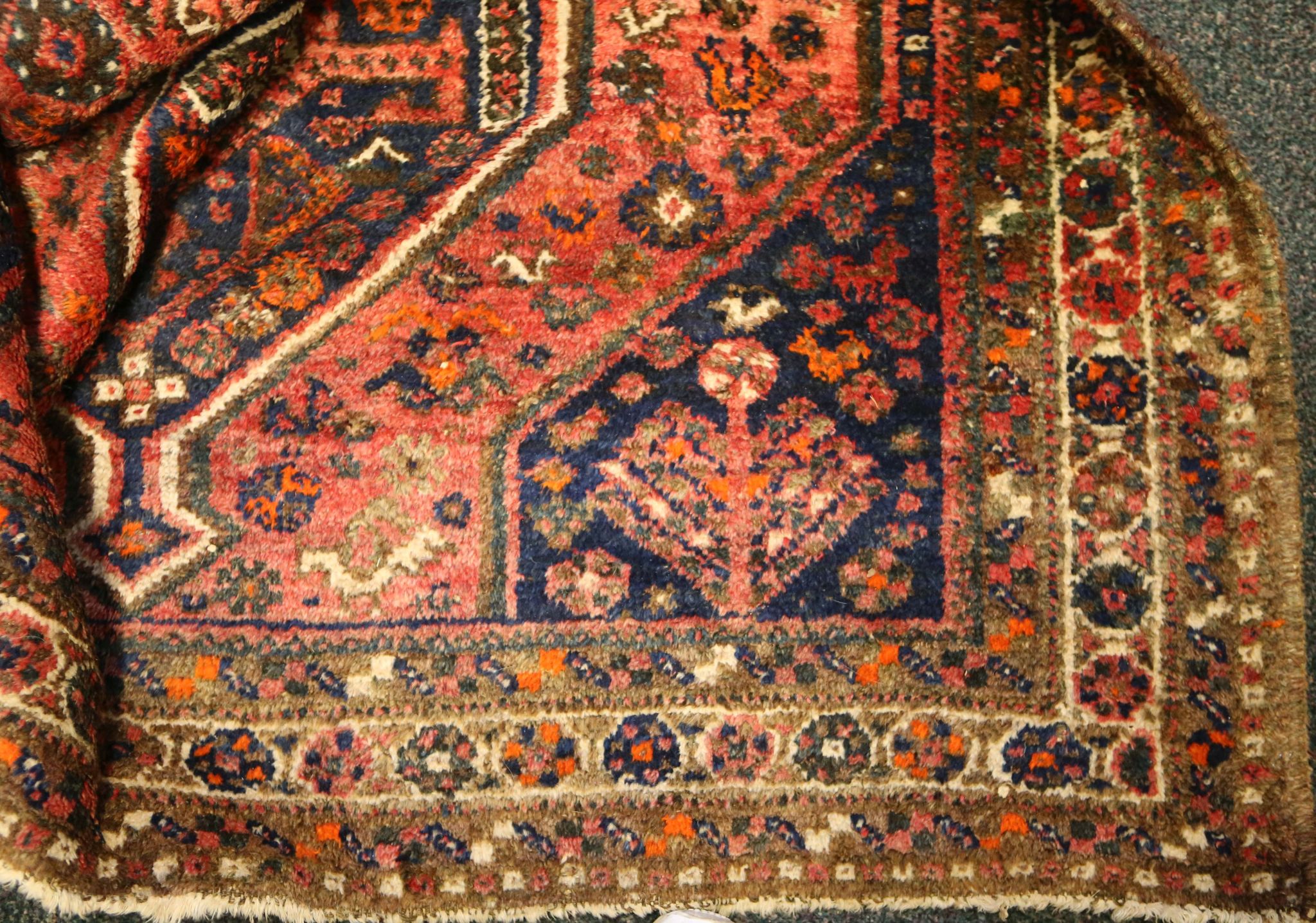 An antique Persian Qashqai rug, with two co-joined diamond lozenges in shades of indigo and deep