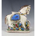 A late 19th Century Ottoman decorated pottery horse / vase on base.