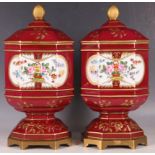 A pair of Sèvres style red ground porcelain octagonal jars and covers, gilt and floral decoration,