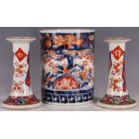 An Imari brush pot or spill vase with a pair of Imari candlesticks. (3)