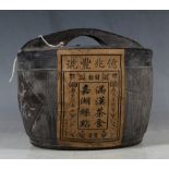 China tea, sealed, in a traditional lidded basket form terracotta pot.