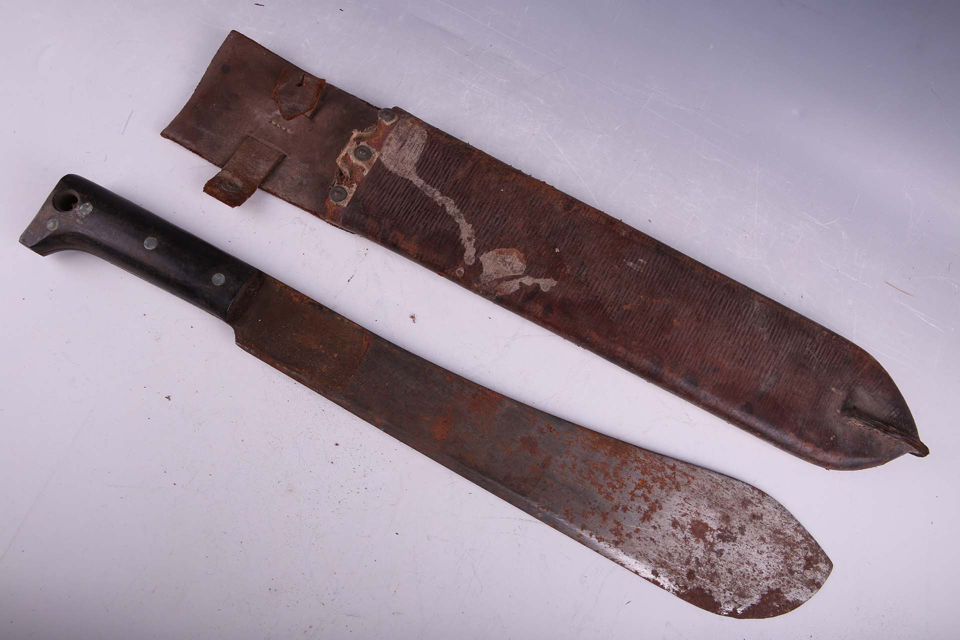 Two WWII machetes, with leather scabbards.