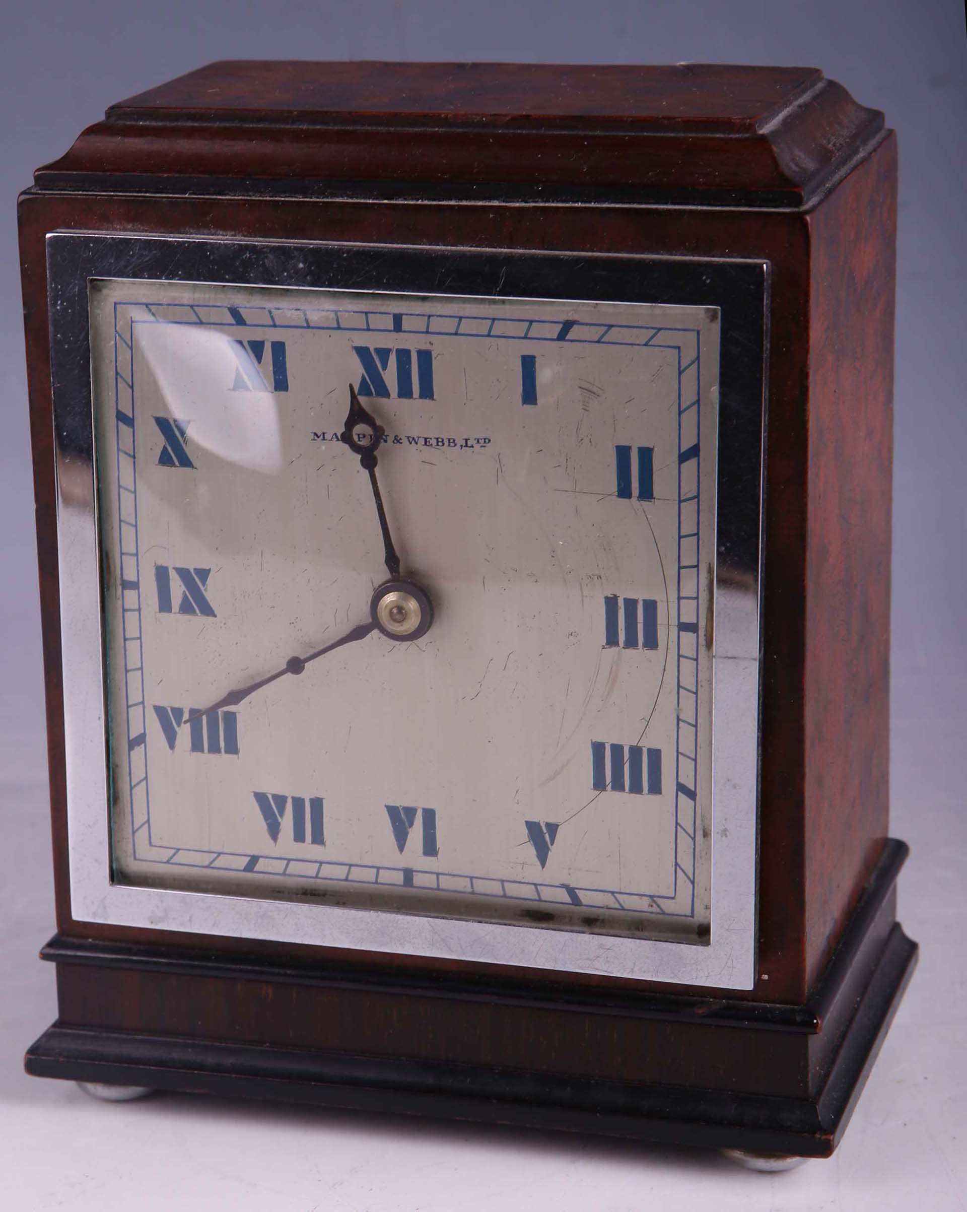 A Mappin & Webb figured walnut and chrome rectangular "Art Deco" mantel clock.