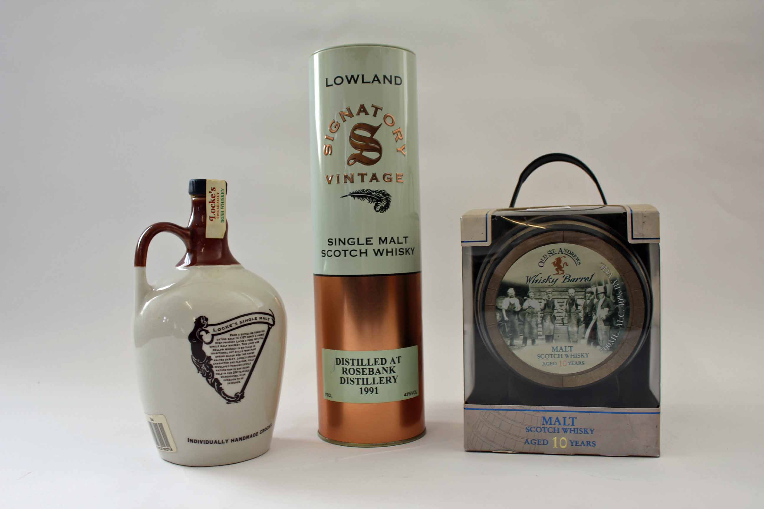 A flagon of Irish Single Malt Whisky (8-year old), two old St. Andrews 10-year old Malts, a