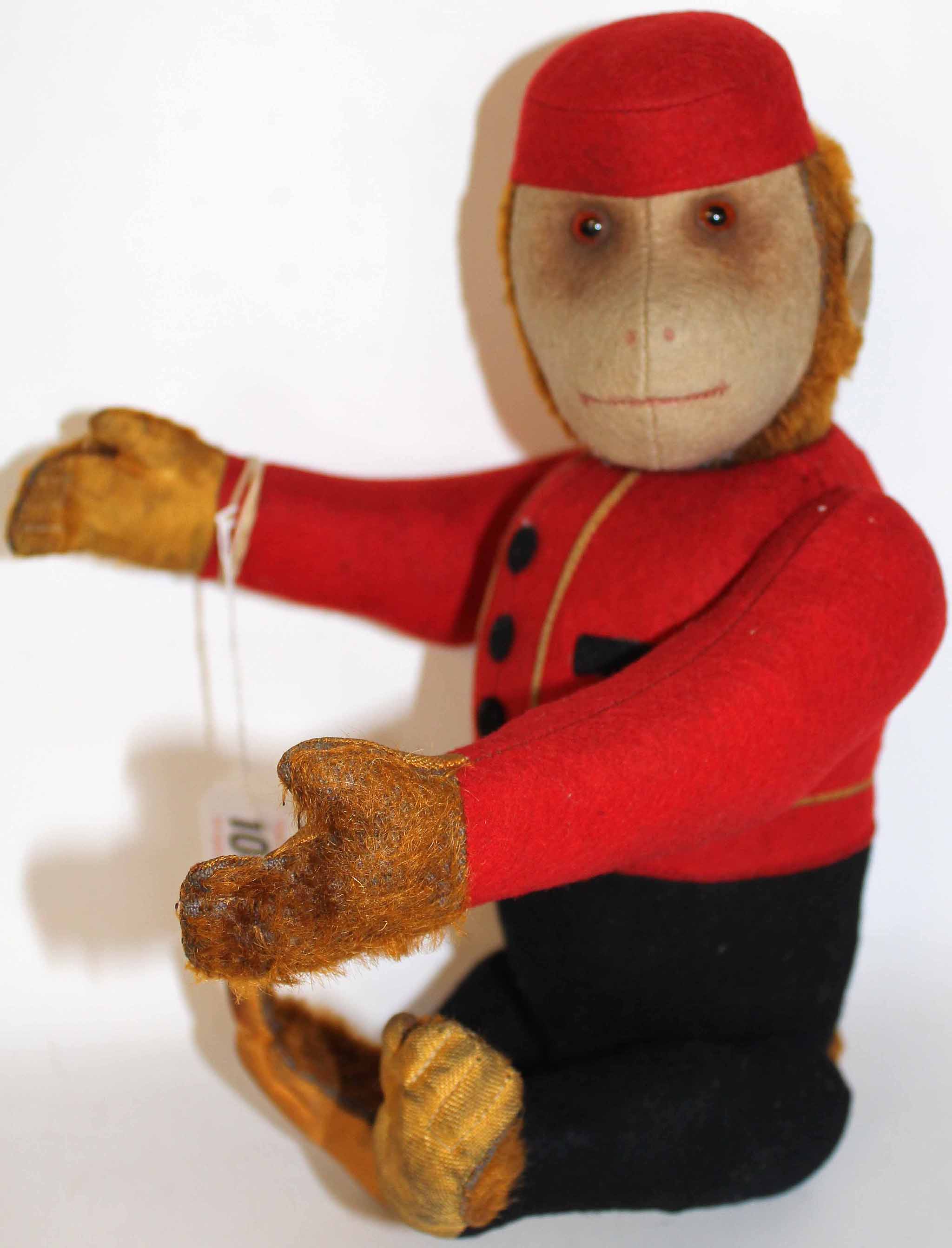 A Schuco Bellman Yes/No mechanical Monkey toy, German 1920s, with brown glass eyes, felt face with