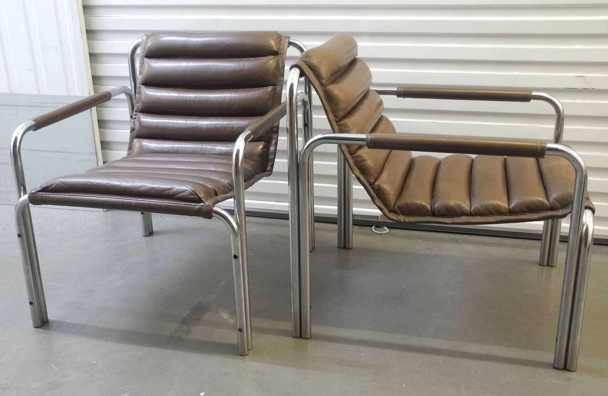 A pair of 1970`s Italian armchairs, brown leather sling seat on tubular chrome frame.