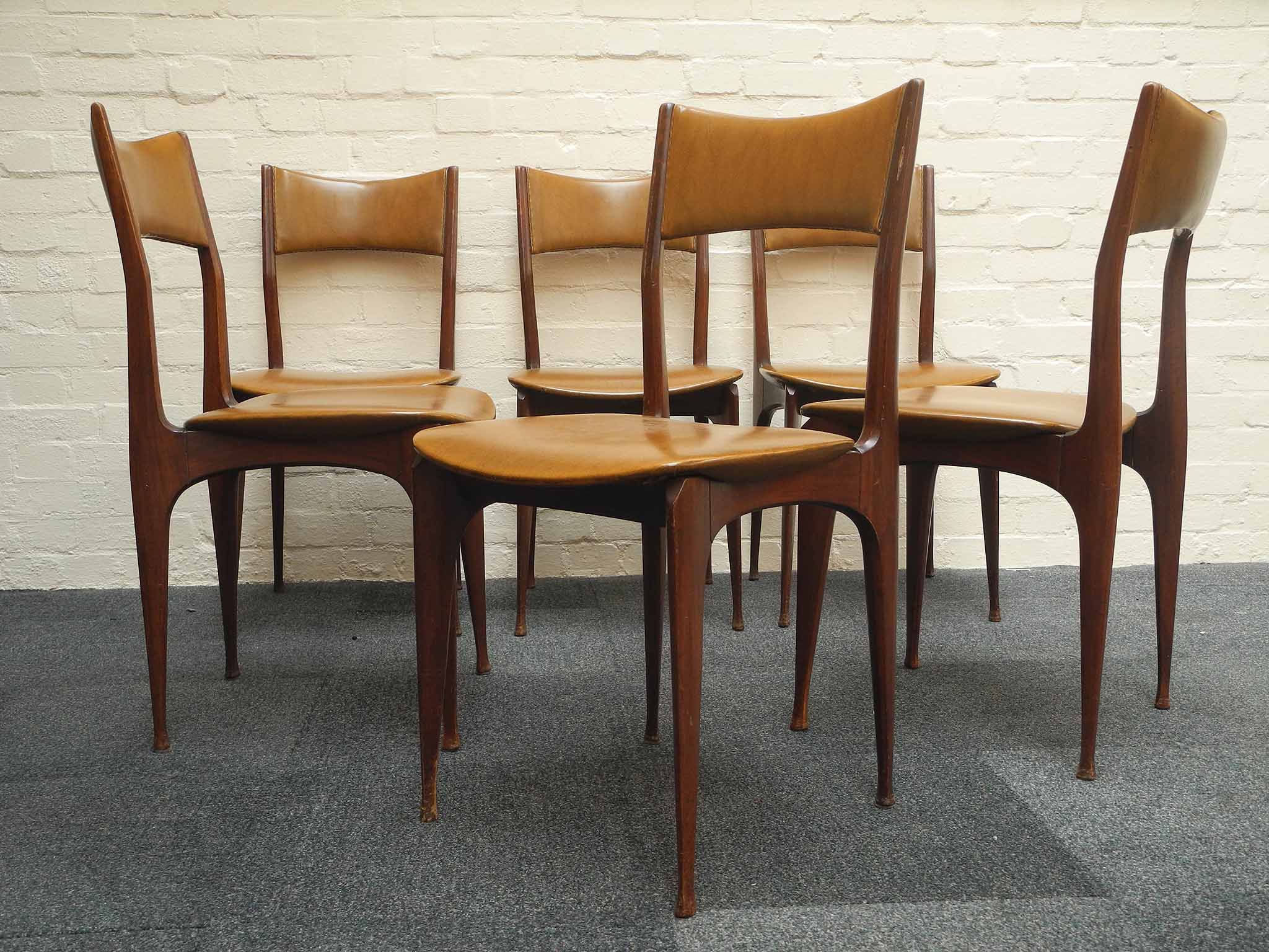 Attributed to Carlo De Carli for Cassina, six walnut dining chairs, circa 1950, some chairs with