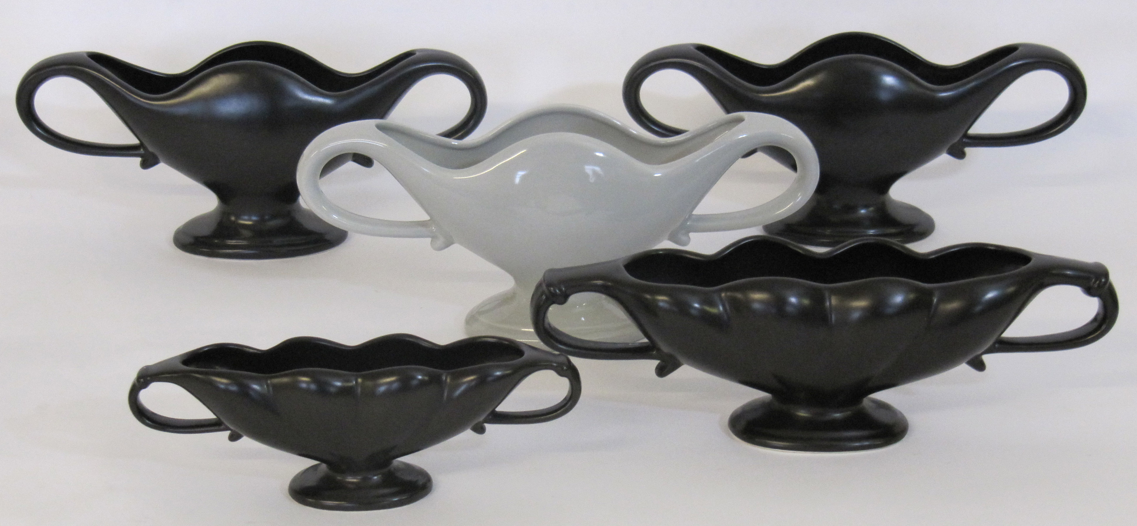 A set three Fulham Pottery flower vases, designed by Constance spry, two with black glaze and one