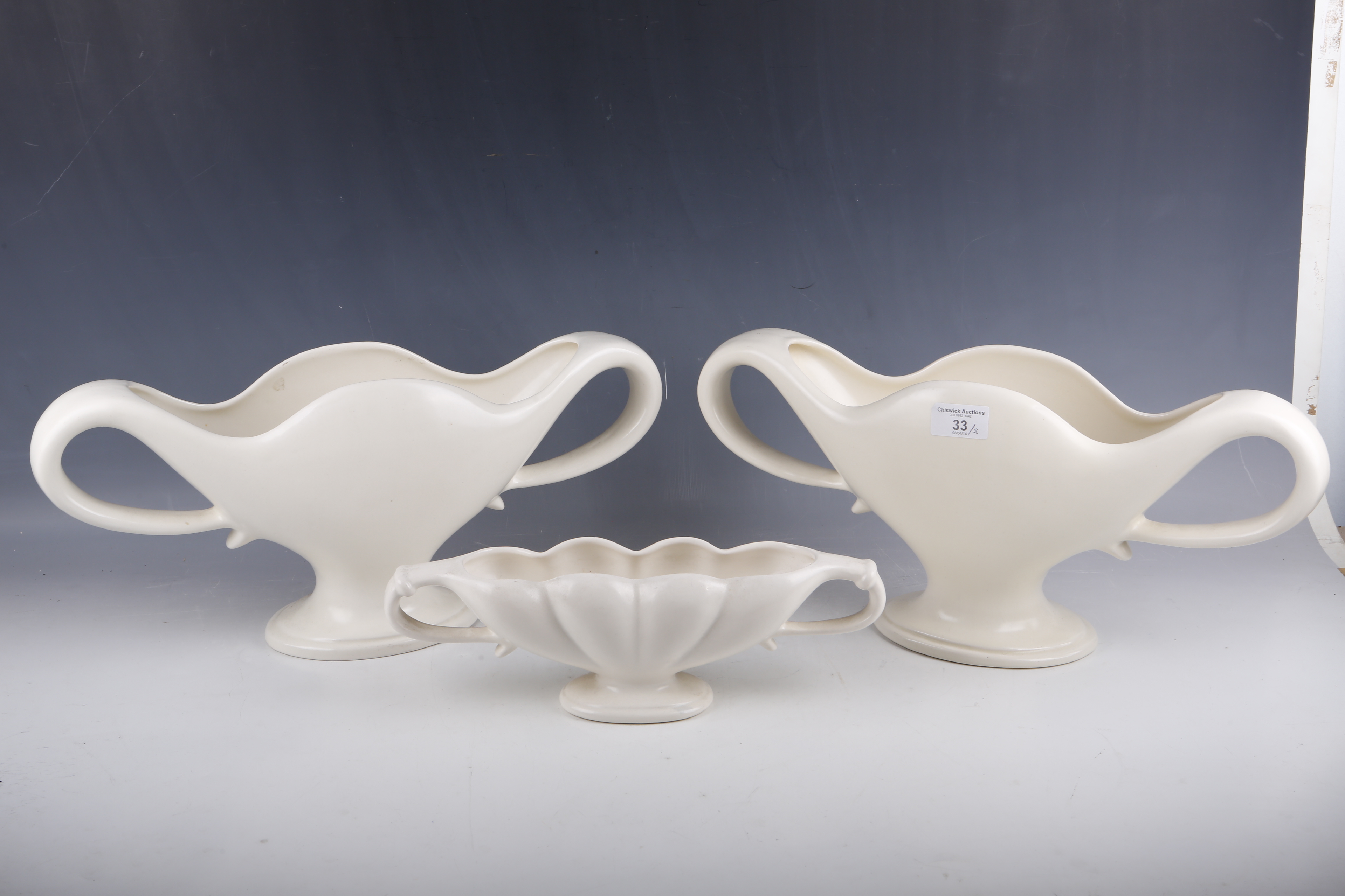 A pair of Fulham Pottery flower vases, designed by Constance Spry, with ivory glaze and twin loop