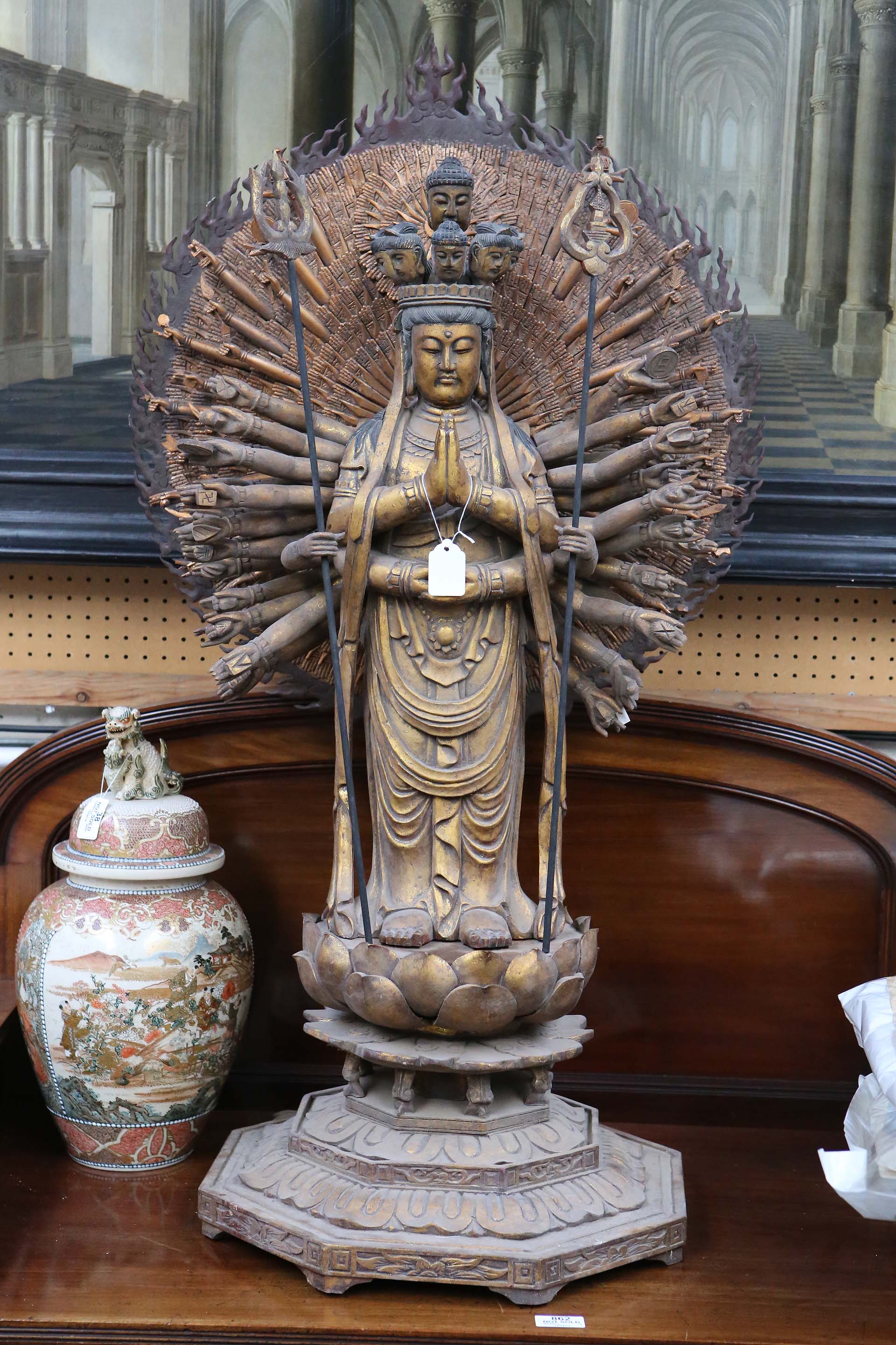 A Chinese gilt hand carved wooden god Avalokitesvara, Buddha, sun ray multi hand carving above his