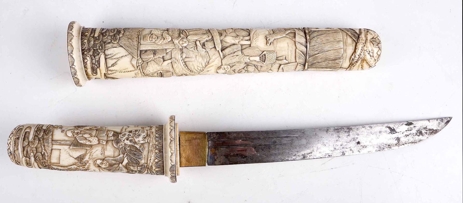A good quality late 19th Century Japanese tanto, the ivory scabbard and handle carved with figures