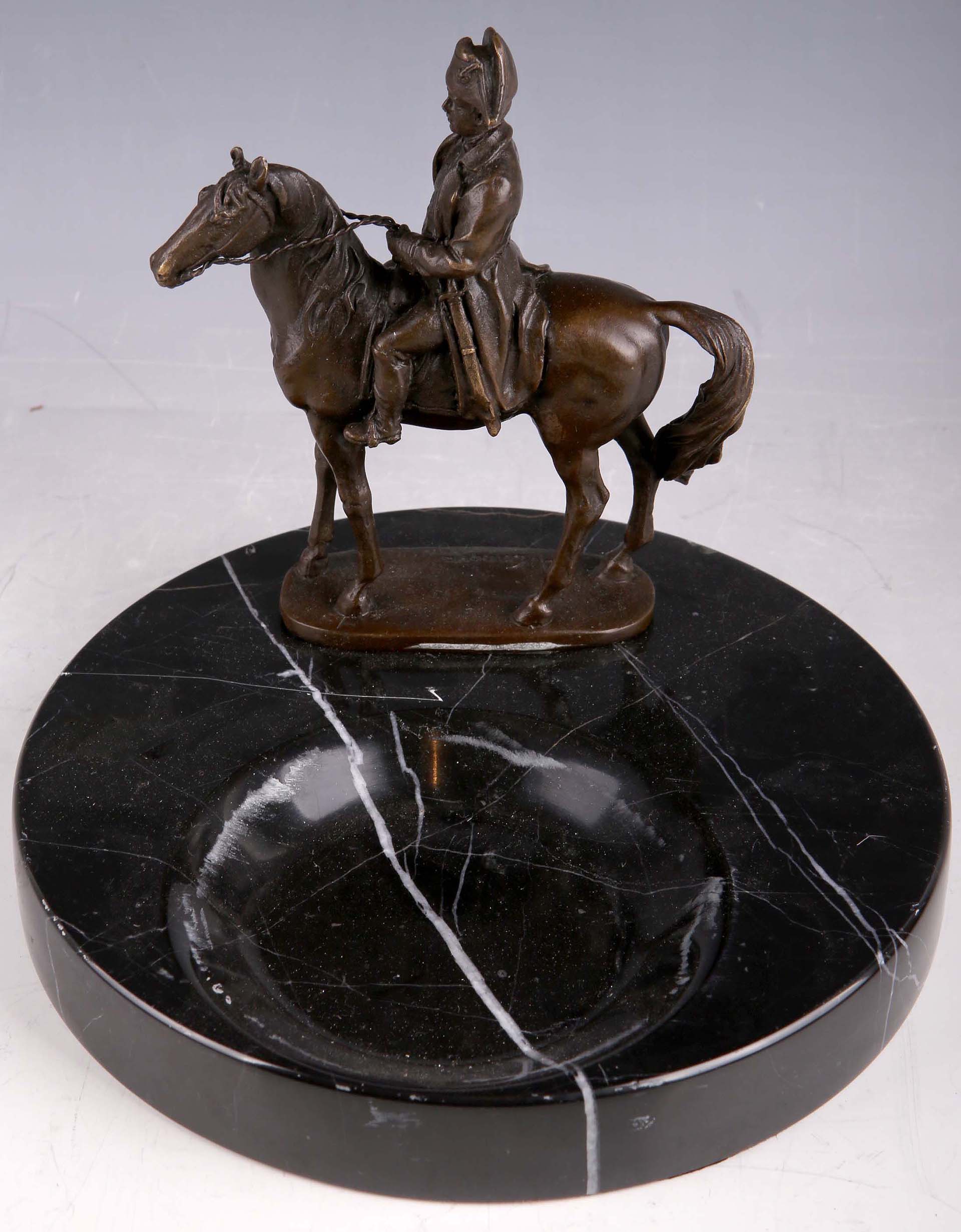 A black marble ashtray surmounted with a bronzed figure of Napoleon astride a horse.
