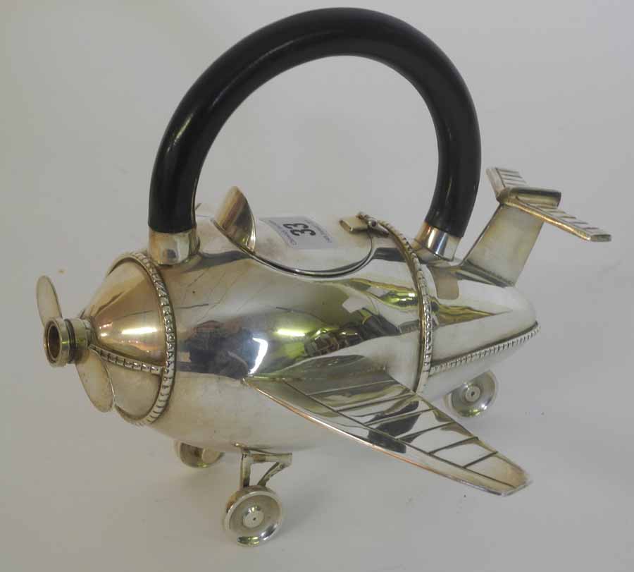 A 20th Century silver plated novelty tea pot in the form of an aeroplane (with spinning