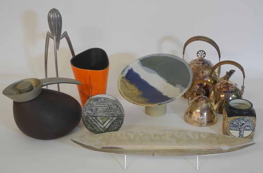 A Georg Jensen hot water jug, a three piece silver plated tea set, a Stark lemon squeezer, and other