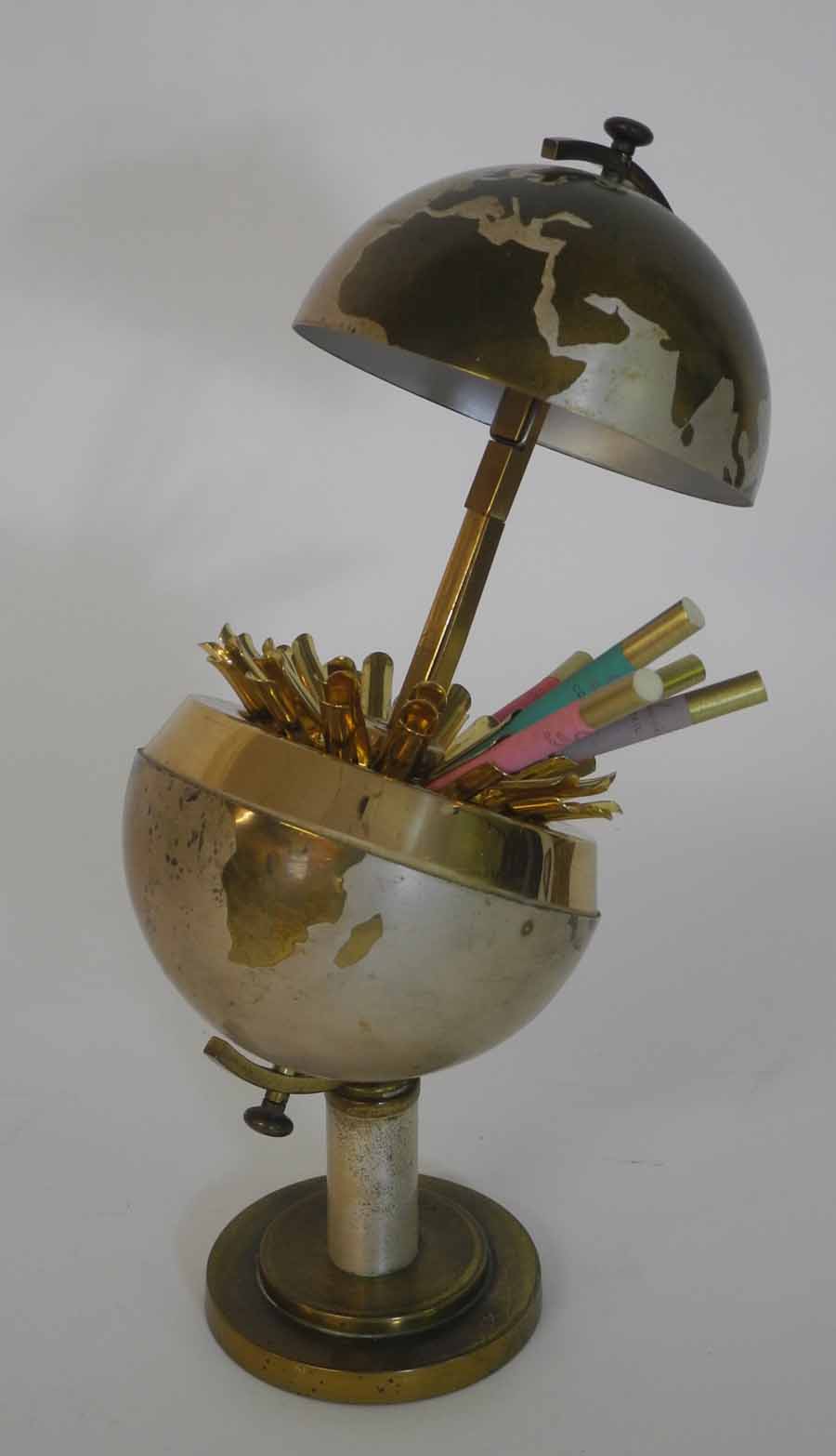 A Globe of the World cigarette dispenser, brass finish on brass stepped stand, and a Palissy six