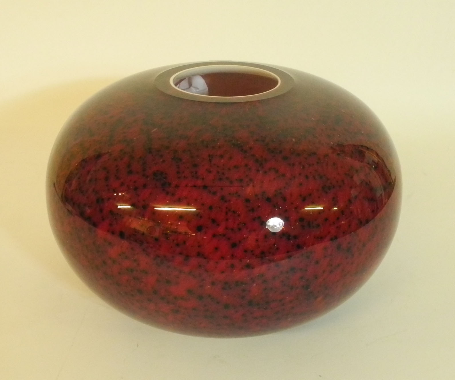 A modern Lambert glass vase, red and black speckled cased glass. 30cm diameter x 20cm high