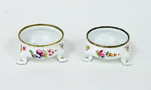 A pair of Bilston enamel salts, circa 1790, of compressed circular form decorated floral sprays on a