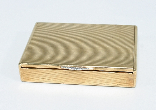 A 9ct gold box by Cartier, 1934, of rectangular form with striated engine decoration, with a diamond - Image 2 of 2