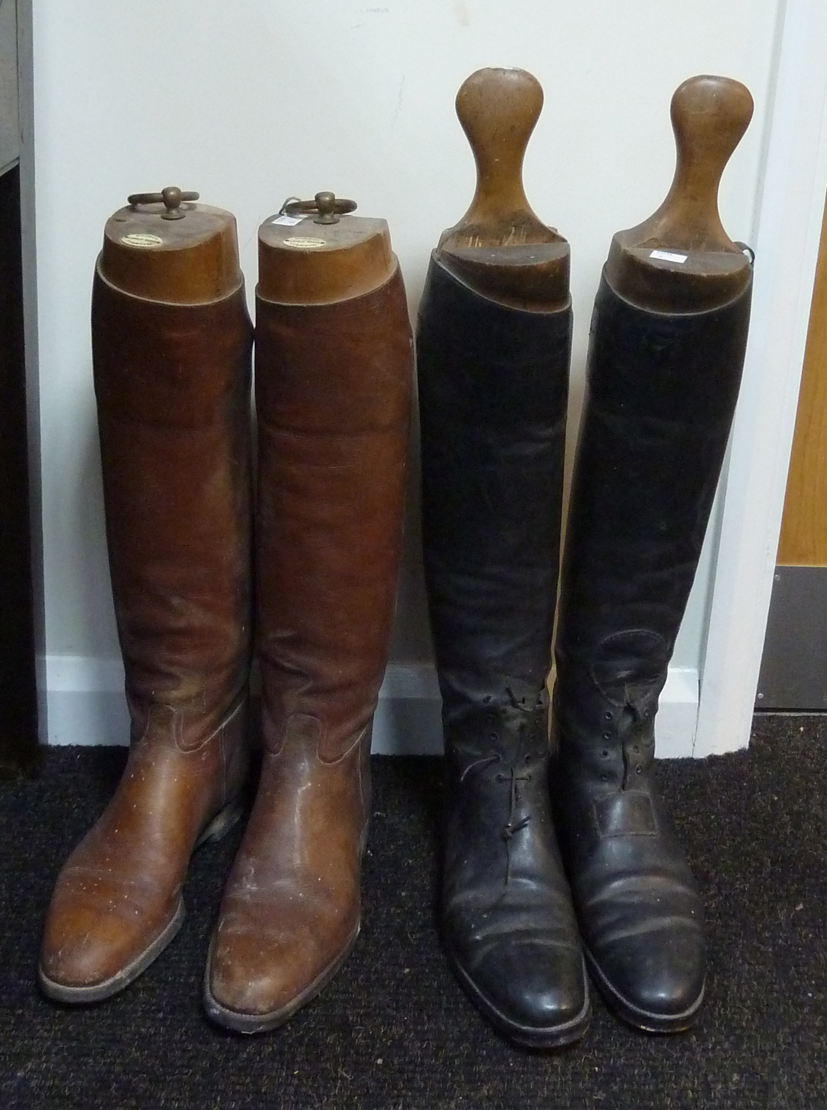 A pair of brown leather riding boots, by Maxwell, Dover St, London and a pair of black leather