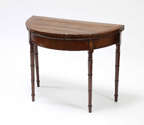 A George III mahogany semi-circular card table, with cross banded top, with inlaid shell