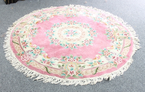 A circular Chinese rug of pink ground, 173cm (68") diameter and a lime green ground runner, 259cm