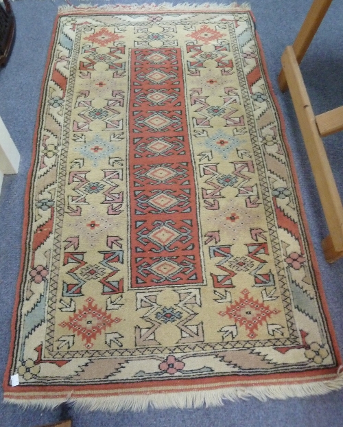 A Turkish rug of geometric design, 183cm x 122cm (72" x 48") and a smaller similar rug