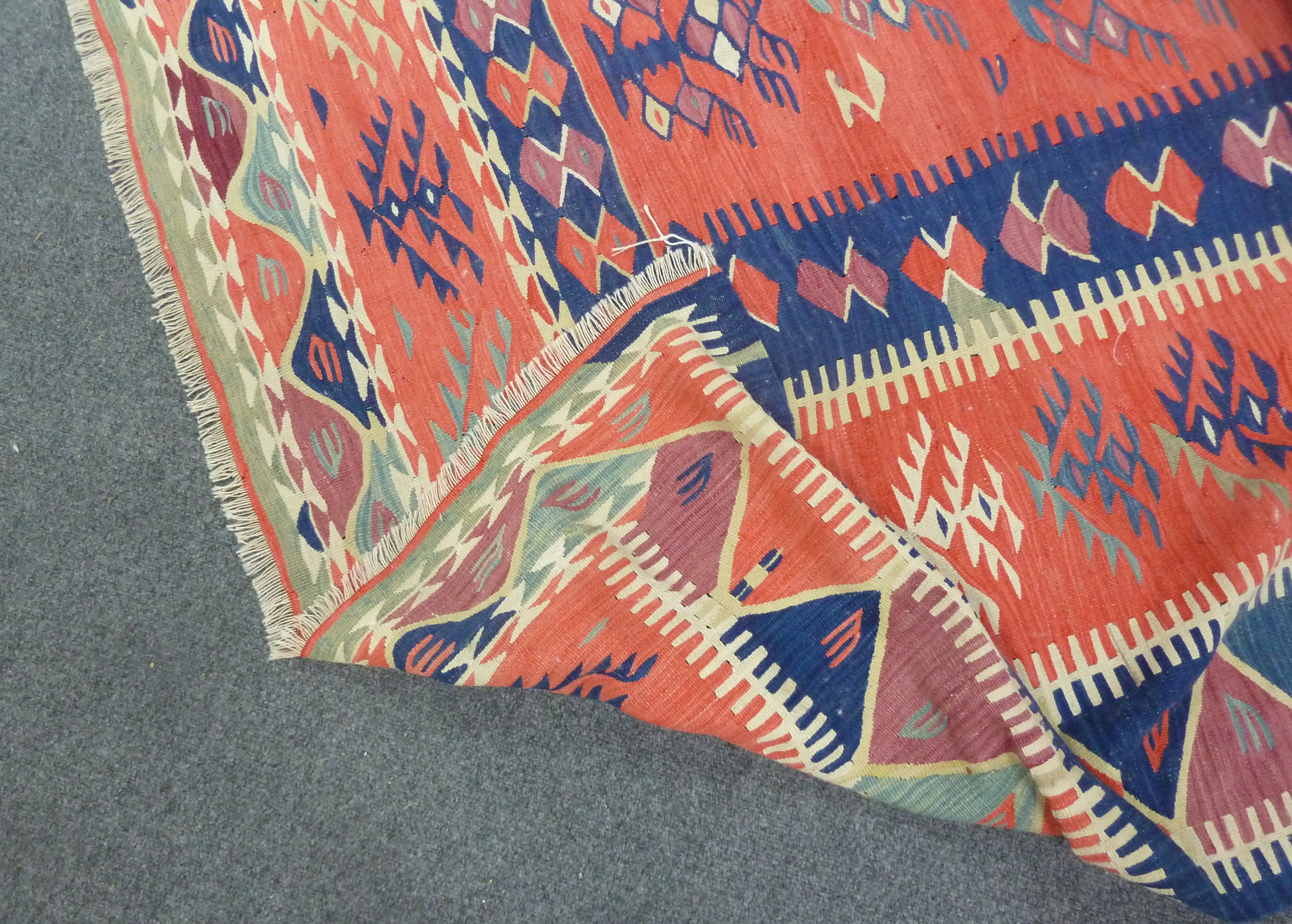 A Kelim rug with bright geometric designs on a tomato red ground, approximately 335cm (132") long - Image 2 of 2