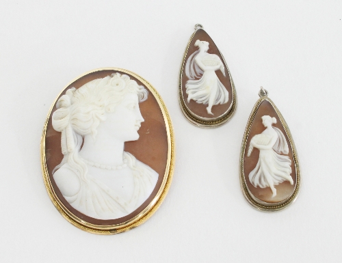 An oval shell cameo brooch depicting a lady in profile in a gold frame and a pair of tear shaped
