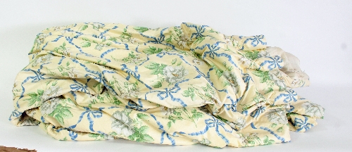 A pair of cream chintz curtains with white rose and blue ribbon design, lined and interlined,