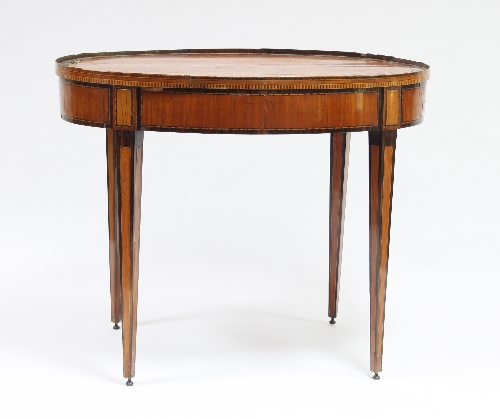 An oval satinwood centre table, circa 1900, the cross banded top with gallery above a banded frieze,