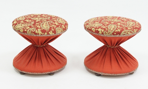 A pair of upholstered fire side stools in the form of diabolos, 43cm (17") diameter