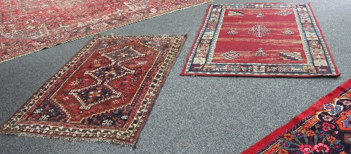 A small Hamadan rug with triple pole medallion on a red ground, 157cm x 100cm (61.75" x 39.5") and