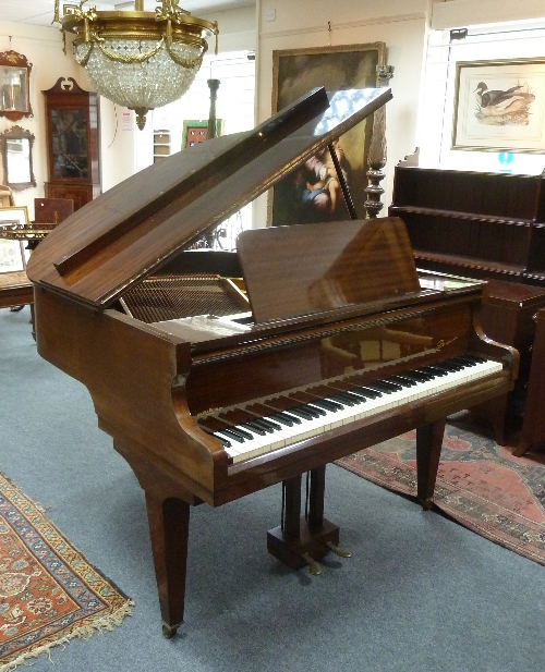 A Danemann baby grand piano retailed by Hickie & Hickie of Reading