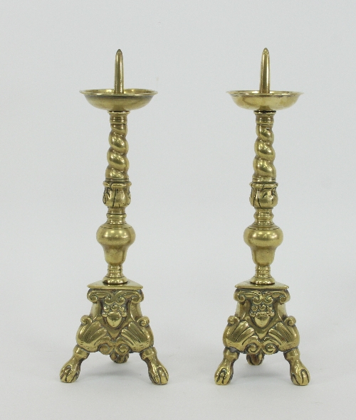 A pair of 17th Century style brass pricket candlesticks with twist turned and baluster stems on