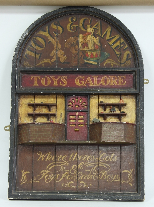 A carved and painted toy shop sign, 94cm (37") high