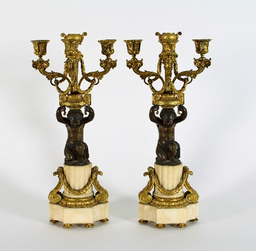 A pair of marble and ormolu mounted Empire table lights, each with central urn nozzle and three-
