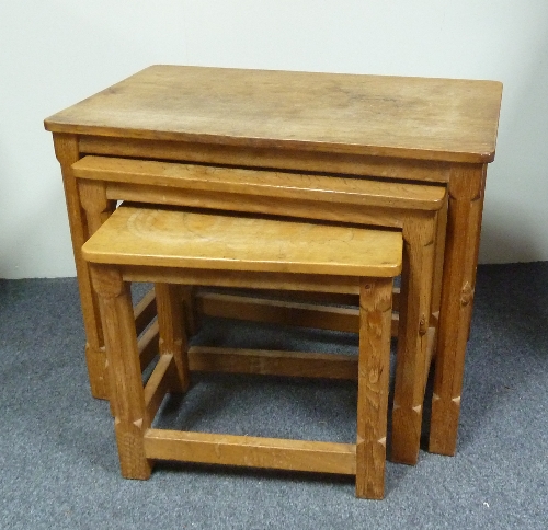 A nest of three oak Mouseman tables, on octagonal legs united by square stretchers, a mouse carved
